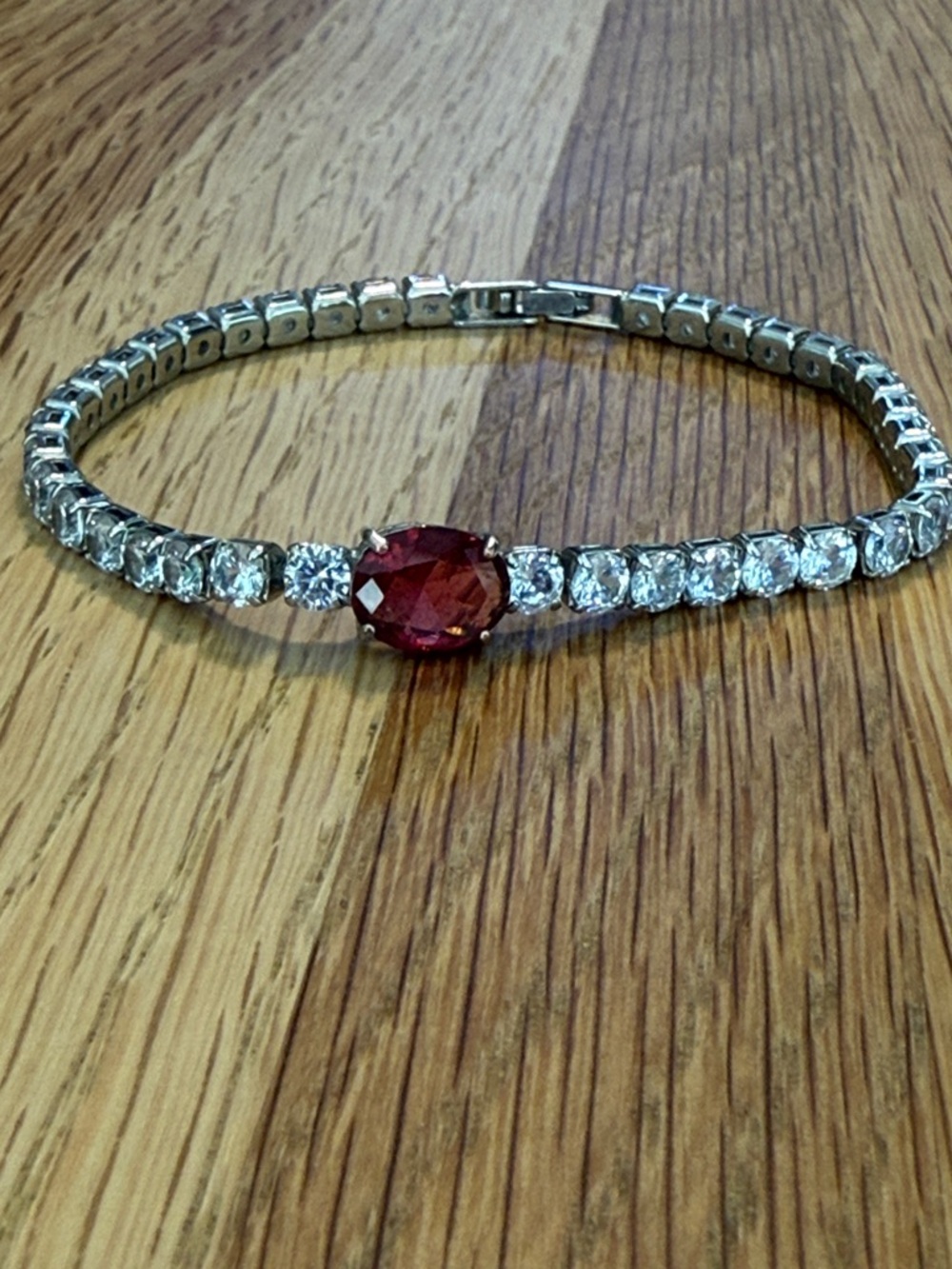 White gold plated Tennis Bracelet with Clear Red Stone. Similar to Pandora.